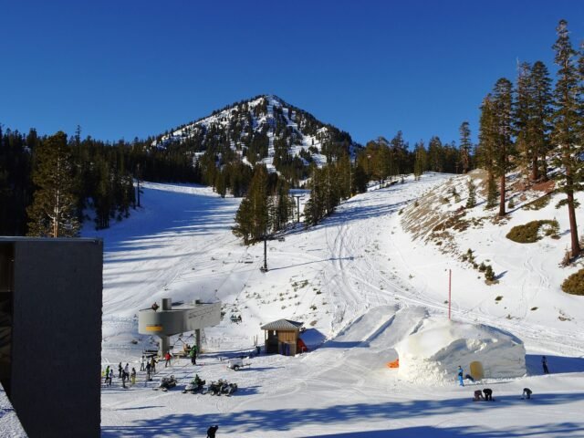Ski slope below a snowy peak