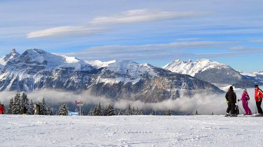 Snow-covered alpine peaks above a ski slope